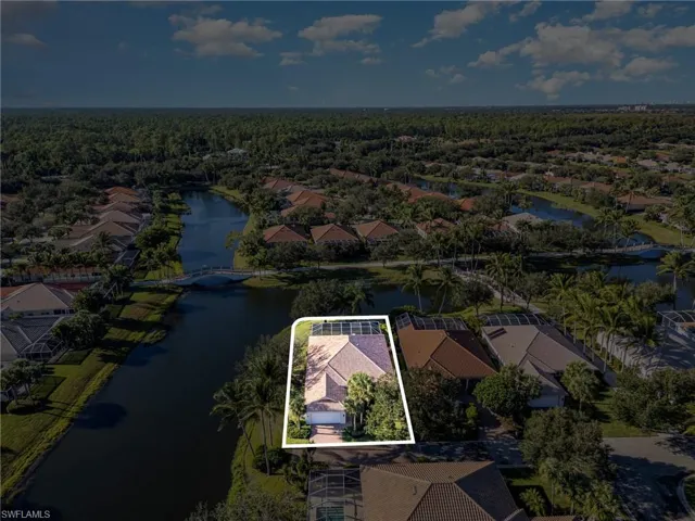 Aerial view of residential area featuring property parcel outlined and a large body of water