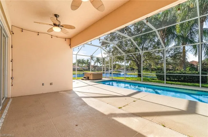 Outdoor pool featuring a patio, a lanai, a sunroom, a ceiling fan, and a water view