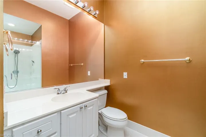 Bathroom with vanity, tile patterned floors, and a shower with door