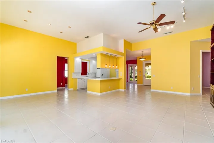 Unfurnished living room featuring light tile patterned floors and a ceiling fan