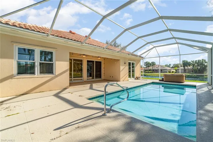 Swimming pool with a sunroom, a patio area, ceiling fan, and glass enclosure
