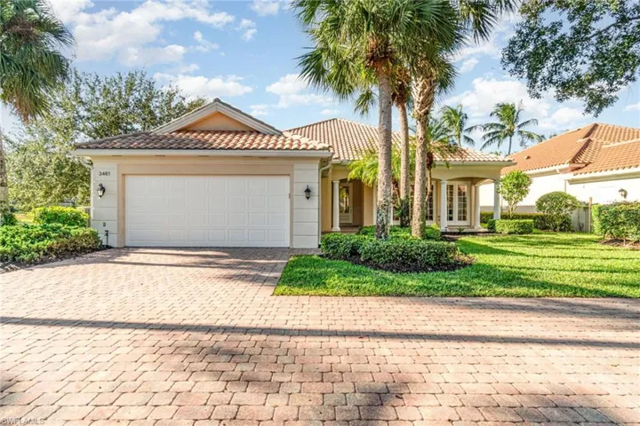 Mediterranean / spanish-style house with decorative driveway, a garage, a tile roof, a front lawn, and stucco siding
