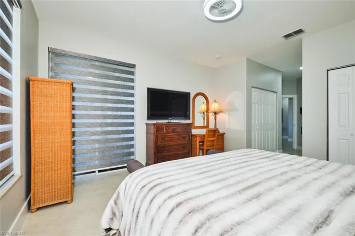 Bedroom featuring multiple closets and light tile patterned floors