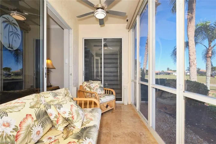 Sunroom / solarium featuring ceiling fan and concrete flooring