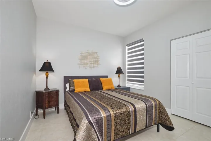 Bedroom featuring a closet and light tile patterned floors