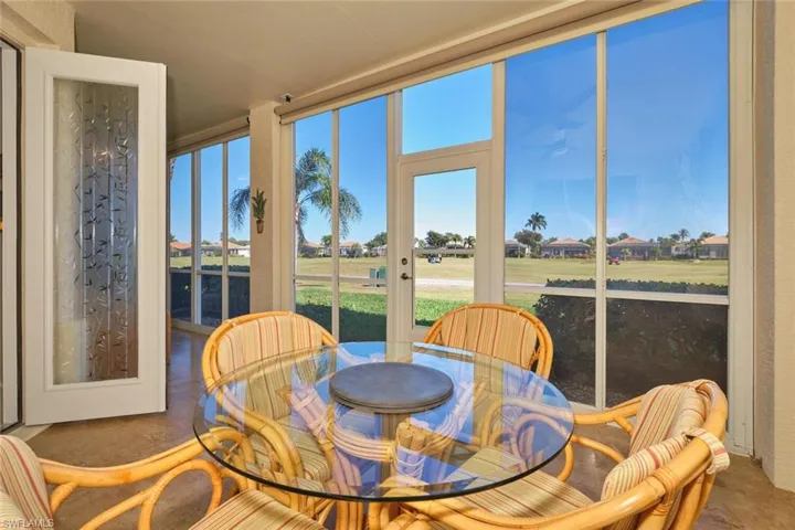 Sunroom with a residential view and golf course view