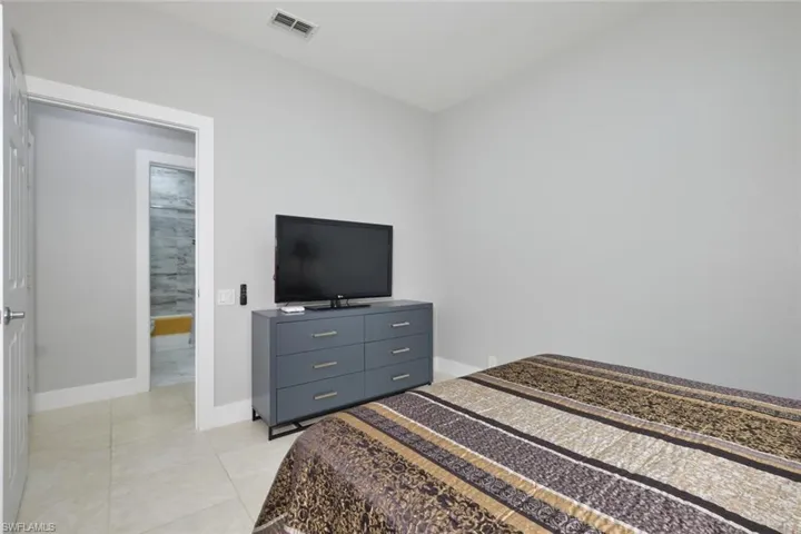 Bedroom featuring baseboards and light tile patterned flooring