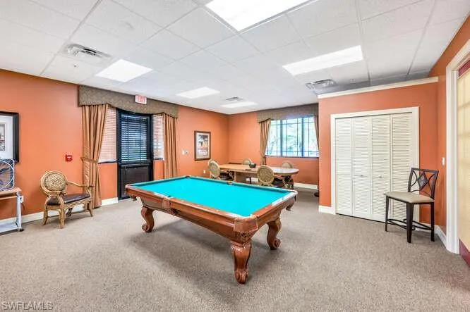 Rec room with a drop ceiling, pool table, and carpet floors
