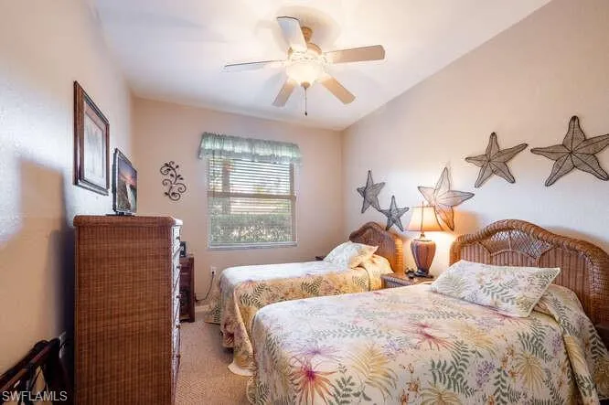 Carpeted bedroom with ceiling fan