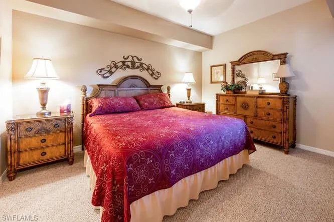 Carpeted bedroom with ceiling fan