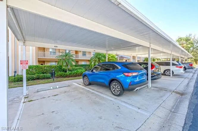 View of parking with a carport