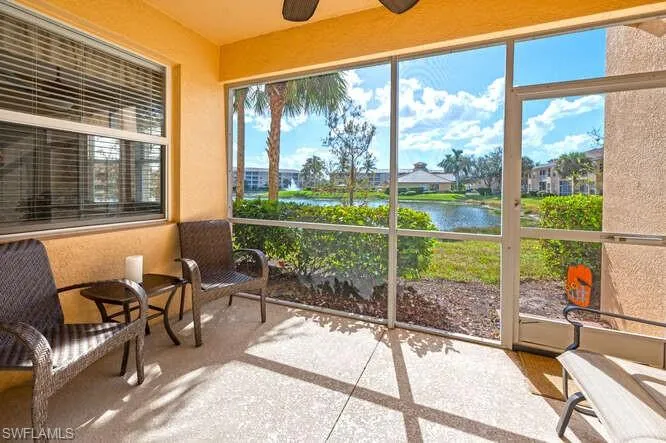 Sunroom / solarium with a water view and ceiling fan
