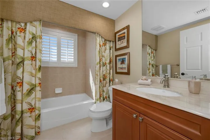 2nd Bathroom featuring vanity, shower / bath combo.