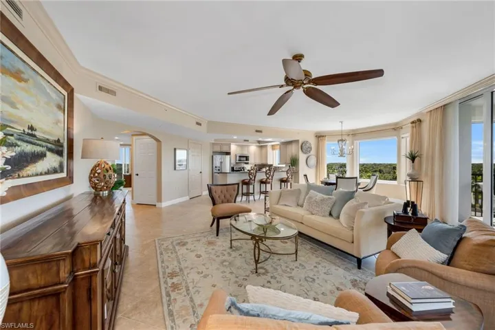 Living area featuring crown molding, custom window treatments, and panoramic views