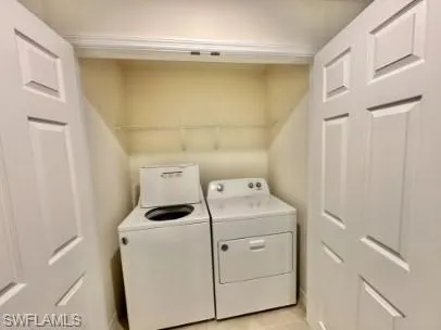 Dedicated laundry closet featuring a top-load washer and a front-load dryer