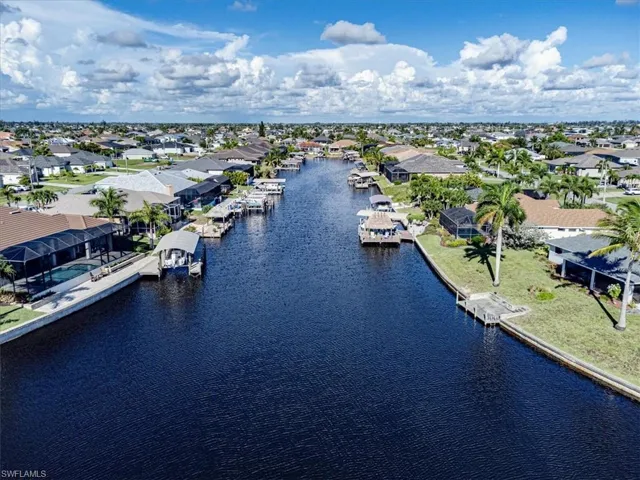 Birds eye view of property with a water view