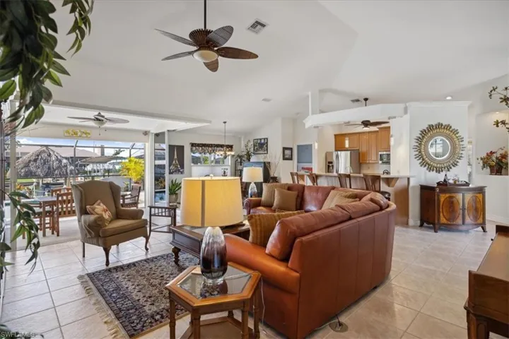 Living room featuring ceiling fan and light tile flooring
