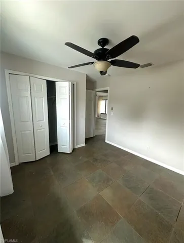 Unfurnished bedroom featuring a closet and ceiling fan
