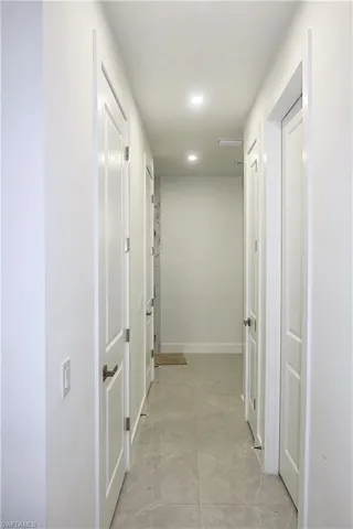 Hall featuring recessed lighting and baseboards