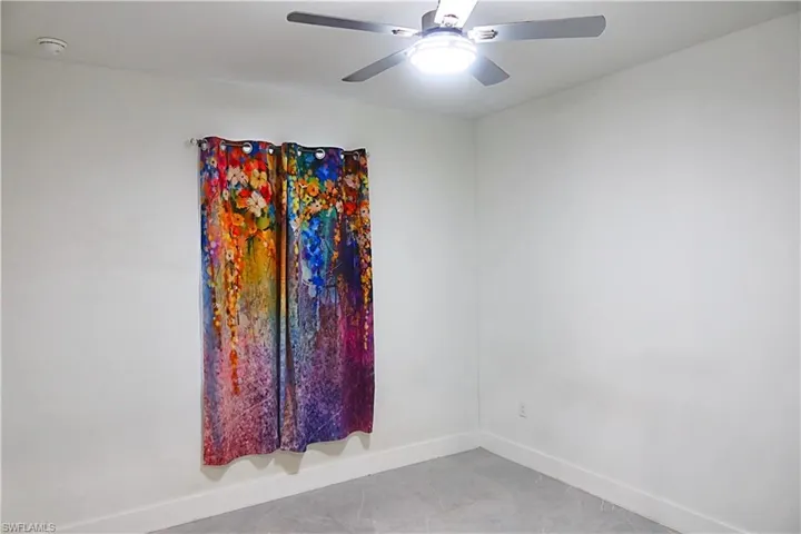 Spare room with ceiling fan and tile patterned floors