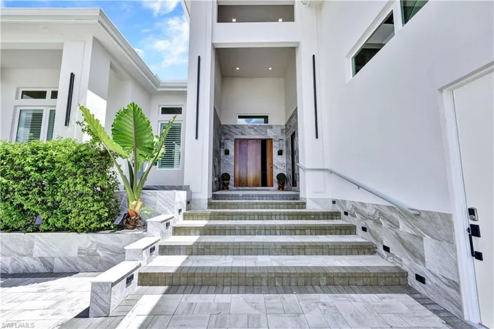 Doorway to property featuring stucco siding