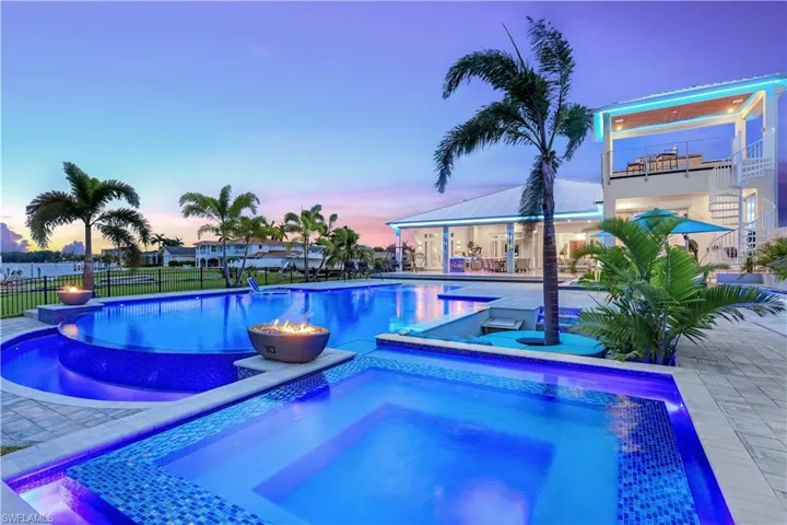 View of swimming pool with an in-ground hot tub and a patio area