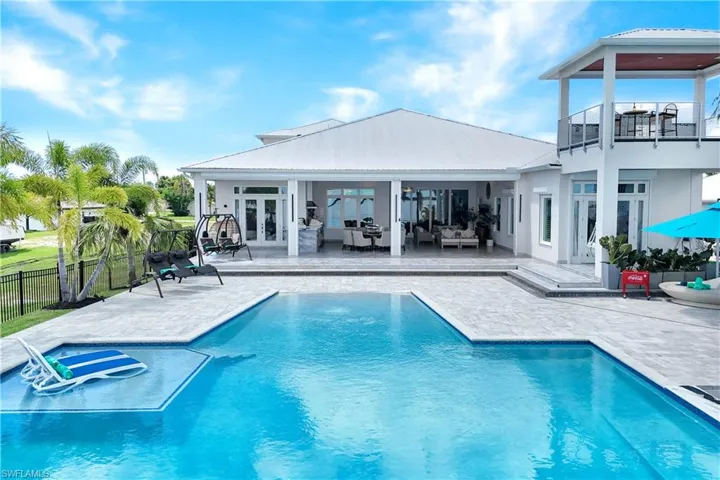 View of pool featuring french doors, a patio, and an outdoor living space