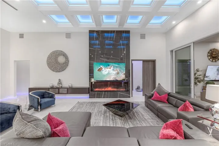 Living room with a towering ceiling and a fireplace