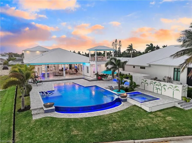 View of pool with a patio, a balcony, a yard, and an outdoor living space with a fire pit