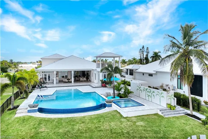 View of pool featuring a patio area, a fenced backyard, outdoor lounge area, and a pool with connected hot tub