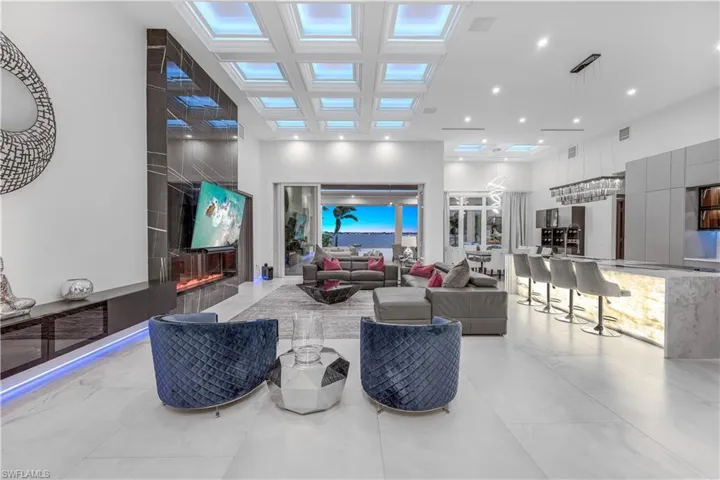 Living room with a premium fireplace and a high ceiling
