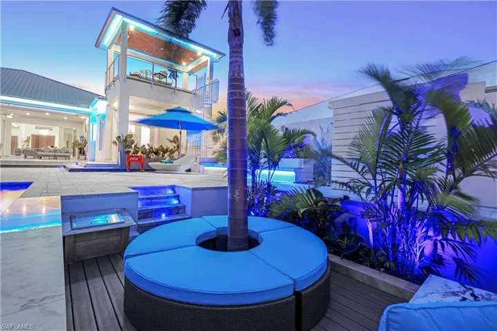 Wooden deck with an outdoor pool, outdoor dining area, and a patio
