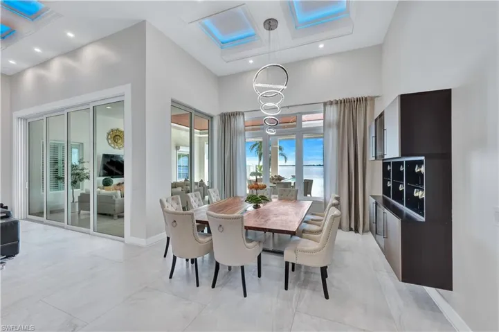 Dining room with a chandelier and a towering ceiling