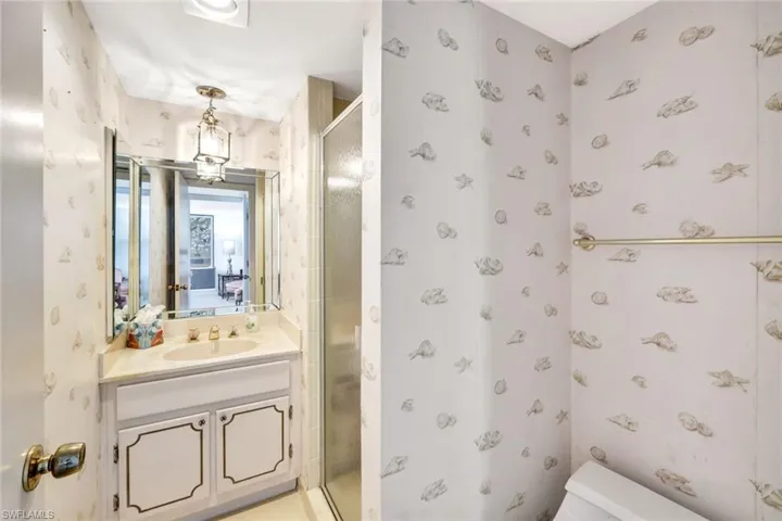 Bathroom with walk in shower, vanity, and toilet