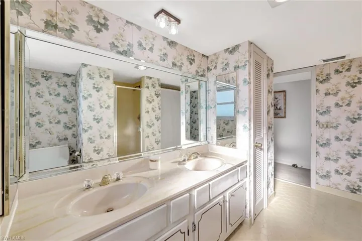 Bathroom featuring vanity, toilet, and walk in shower