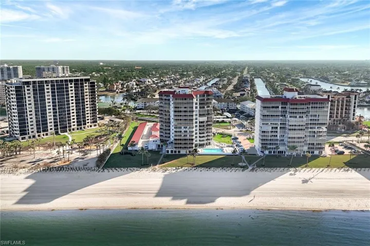 Drone / aerial view with a water view and a beach view