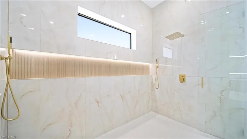 Bathroom with a marble finish shower