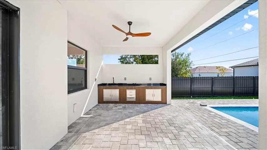 View of patio / terrace with a ceiling fan and an outdoor kitchen