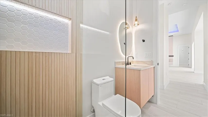 Half bathroom with vanity and toilet