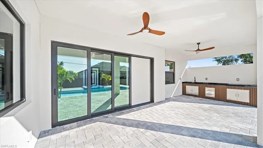 View of patio / terrace with ceiling fan and area for grilling