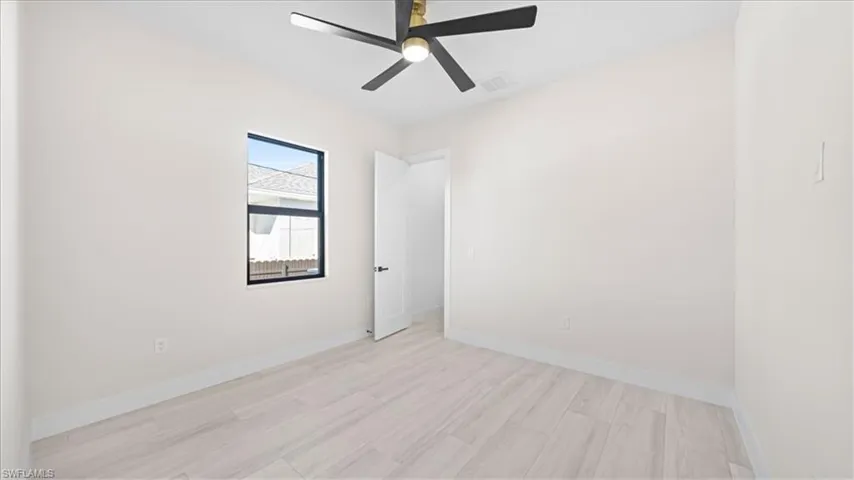 Unfurnished room with light wood-style flooring and a ceiling fan
