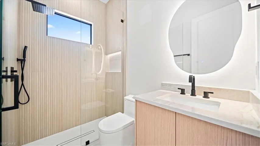Bathroom featuring vanity and a shower with shower door