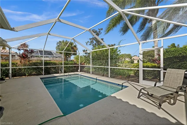 Swimming pool featuring a lanai, a sunroom, and a patio area
