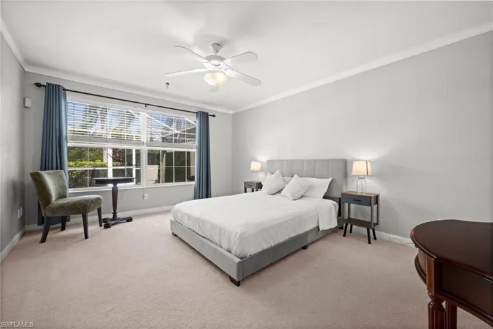Bedroom featuring crown molding, carpet, and a ceiling fan
