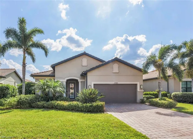 View of front of property with a front lawn and a garage