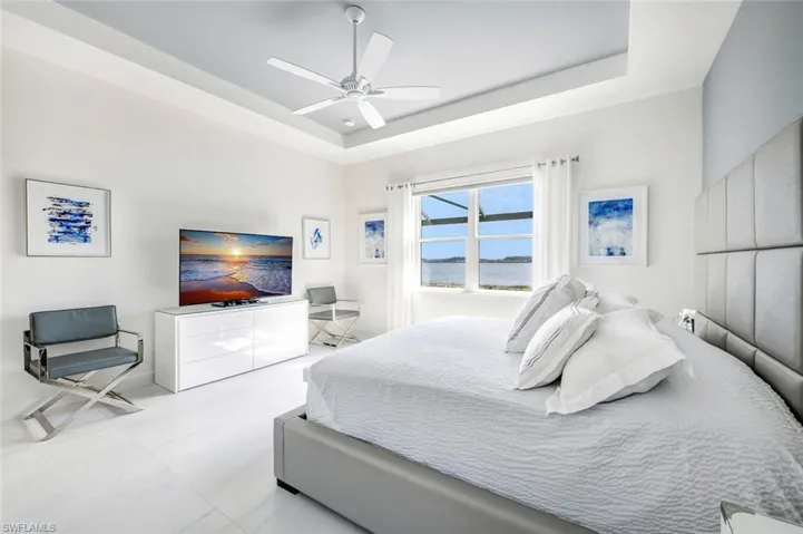 Bedroom featuring a raised ceiling and ceiling fan