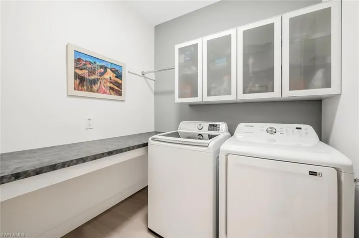 Laundry room with cabinets and washer and clothes dryer