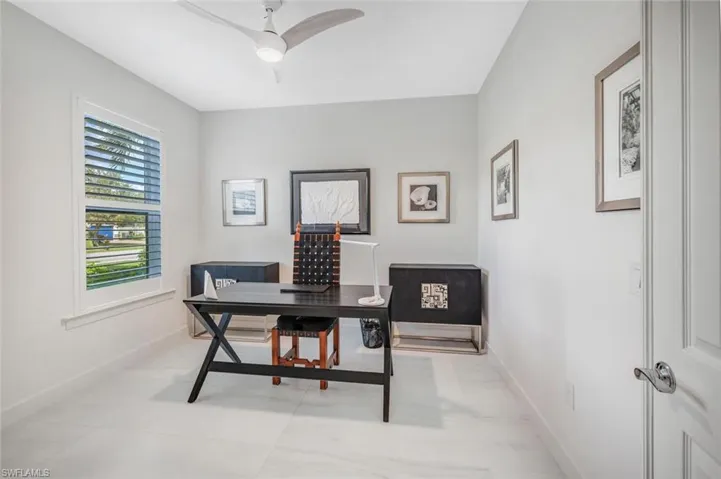 Tiled office space featuring ceiling fan