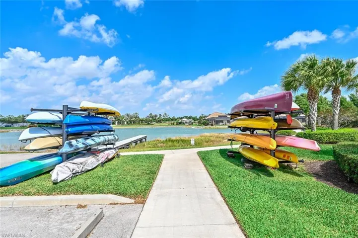 View of community featuring a water view and a yard