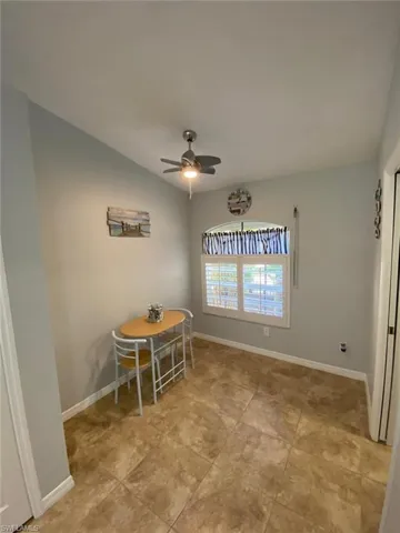 Dining room featuring ceiling fan and lofted ceiling
